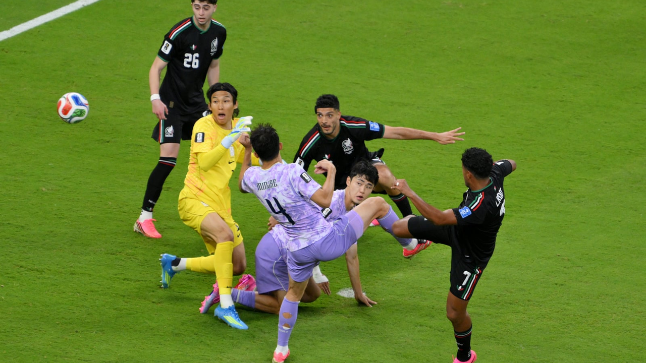 Luis Romo scores through a crowded South Korea penalty area