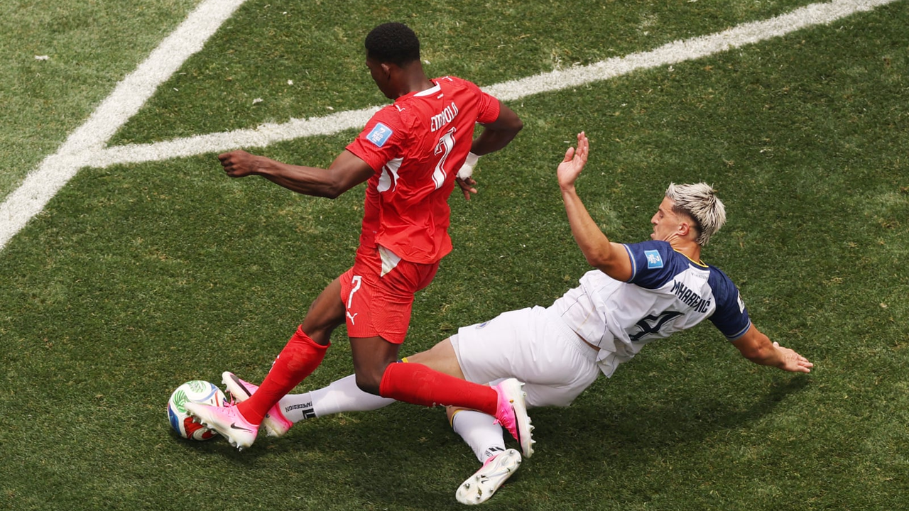 A Bosnia player challenges during Switzerland's late surge