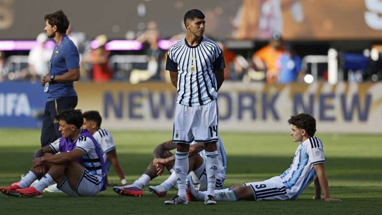 Alejo Sarco stands among players after a youth match