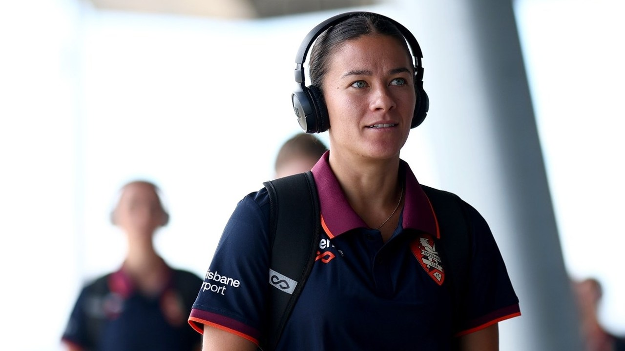 Angie Beard stands in Brisbane Roar clothing