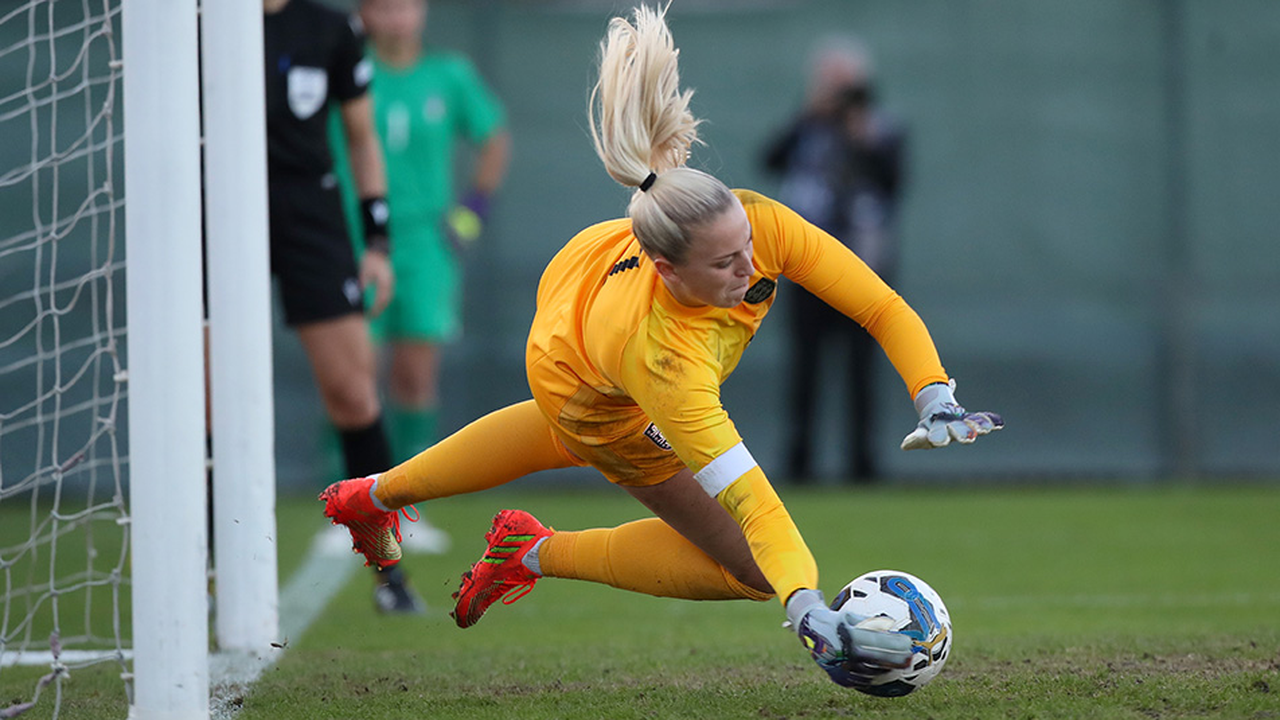 Emily Ramsey saving a penalty for England Women's Under-23s