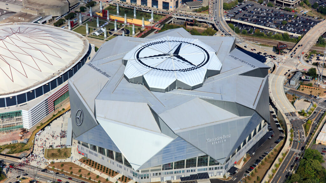 Wide aerial view of Mercedes-Benz Stadium and the surrounding downtown roads