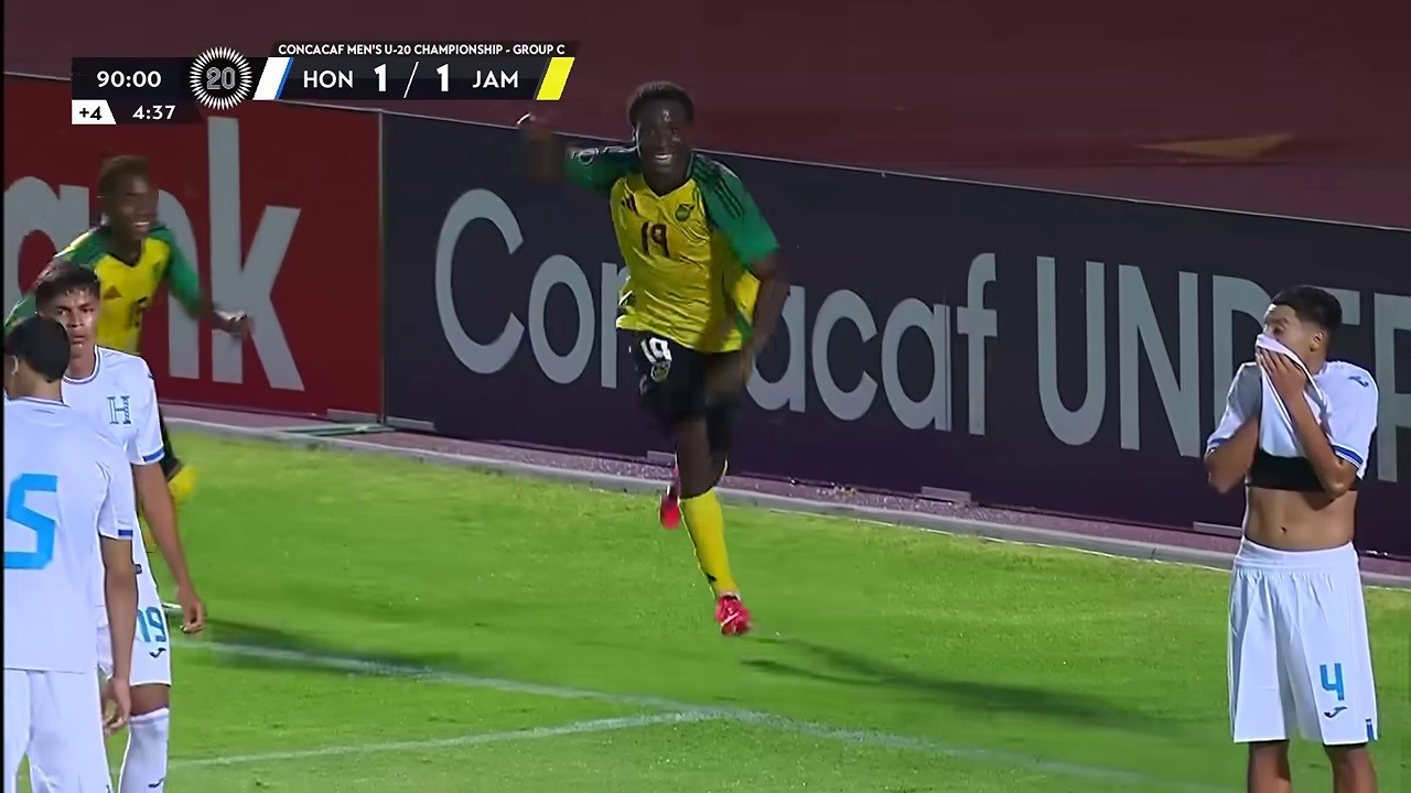 A Jamaica player runs away after the late goal as Honduras players remain near the penalty area