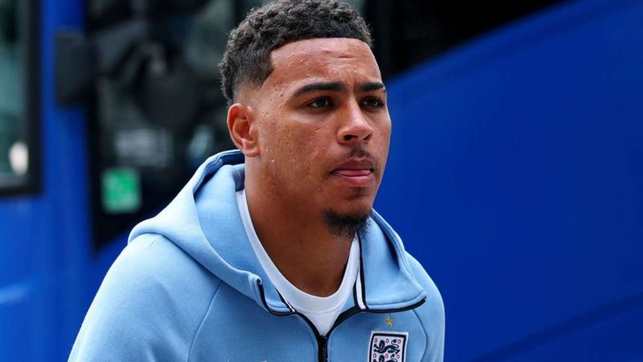 Morgan Rogers arrives with the England squad wearing a blue tracksuit