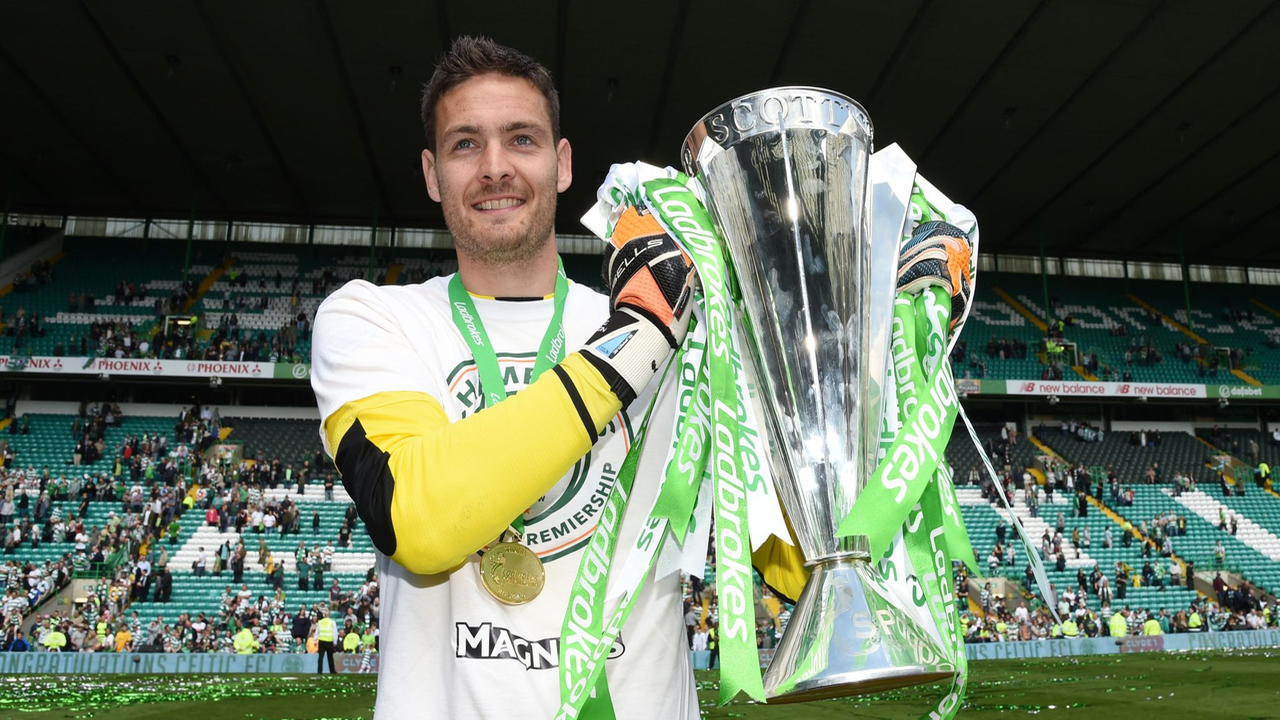 Craig Gordon holds the Scottish Premiership trophy after a title-winning season with Celtic