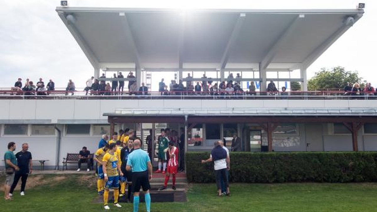 Badener AC players stand near the touchline before a match