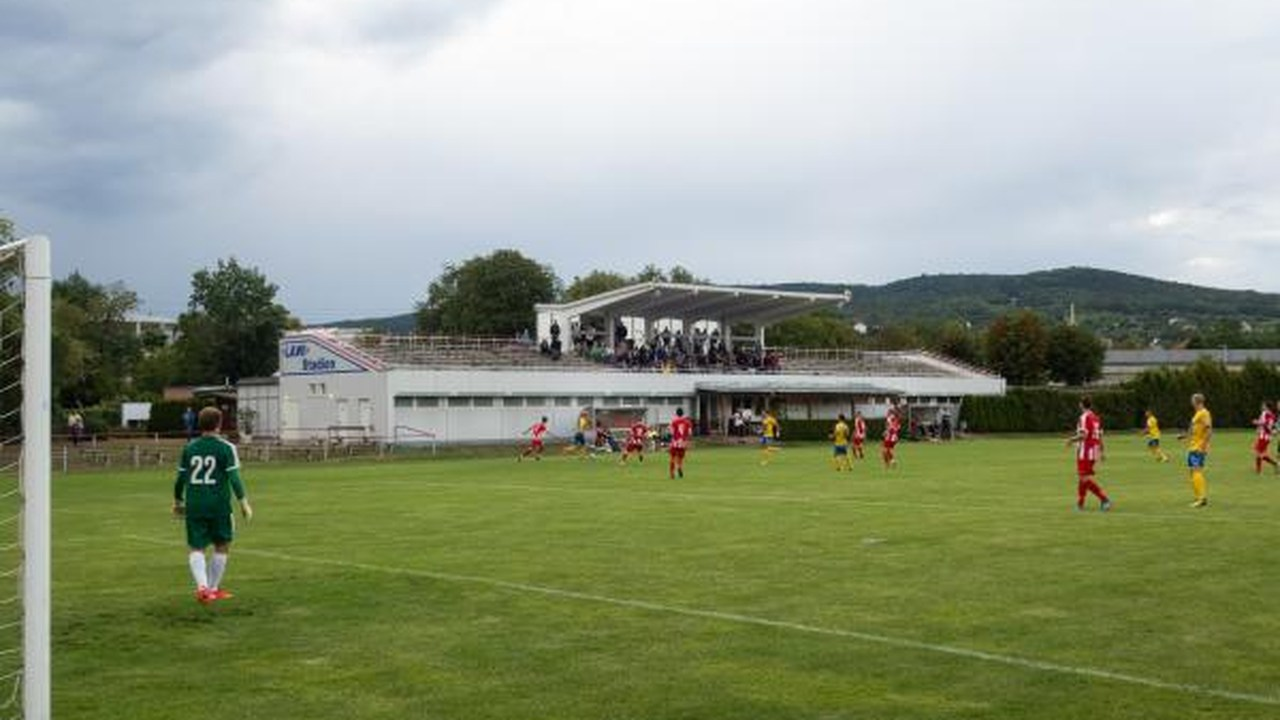 Footballers play on the Badener AC pitch in front of the main stand