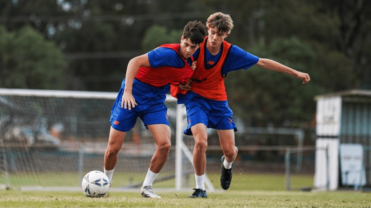 Brisbane Roar academy players contest the ball in training