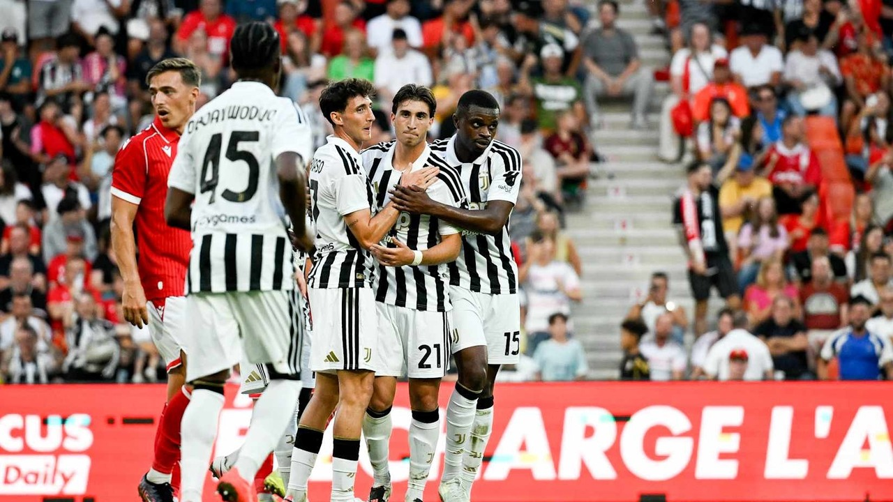 Juventus players celebrate together in black and white shirts