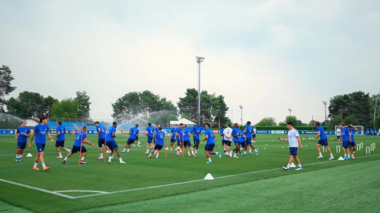 Inter players complete a team training session on an outdoor pitch