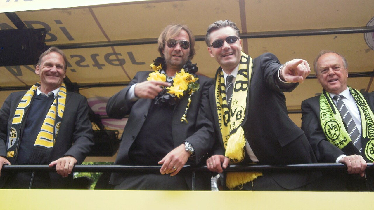 Jürgen Klopp celebrates with players after a football match