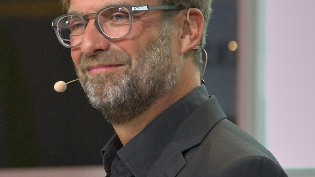 Jürgen Klopp stands beside the football pitch