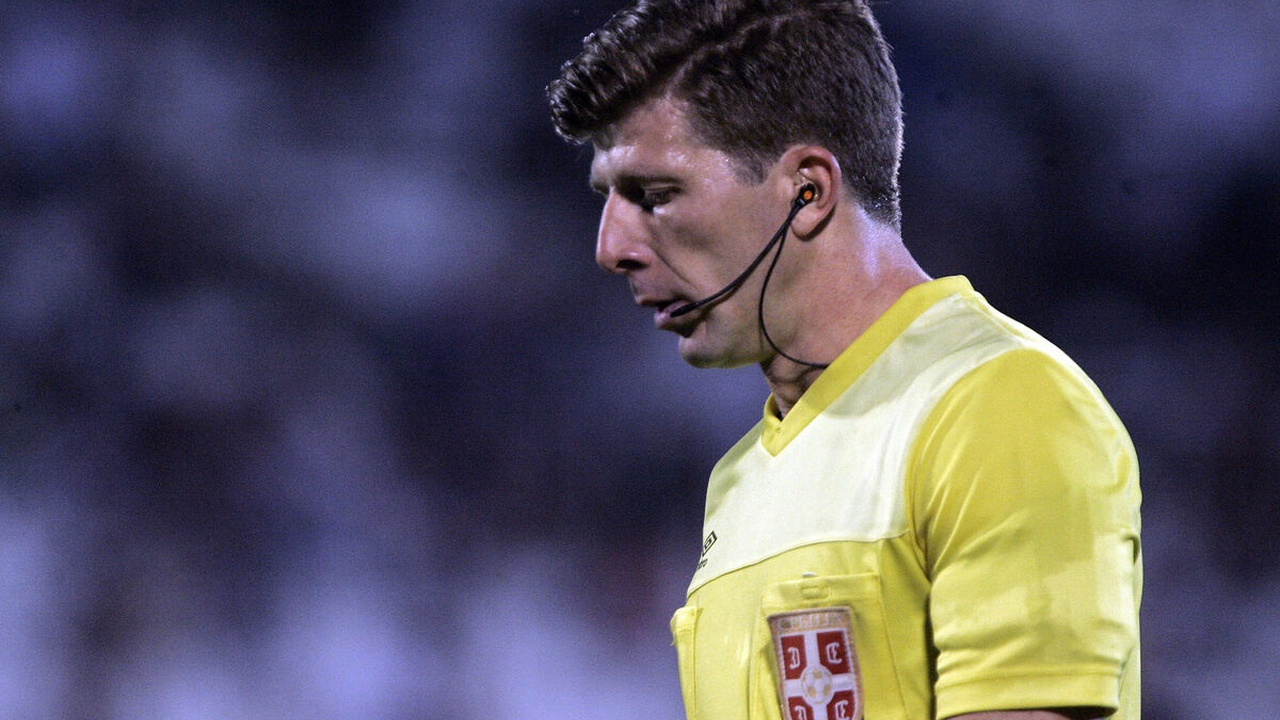 Novak Simovic communicates with players during a football match
