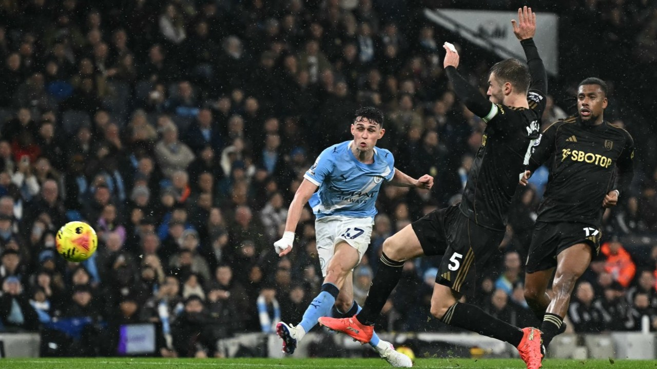 Phil Foden shoots past two defenders for Manchester City