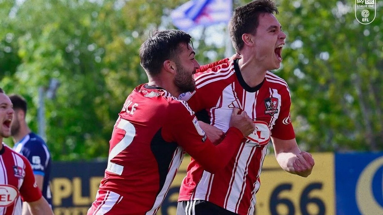 Timur Tutierov celebrates a goal with an Exeter City teammate