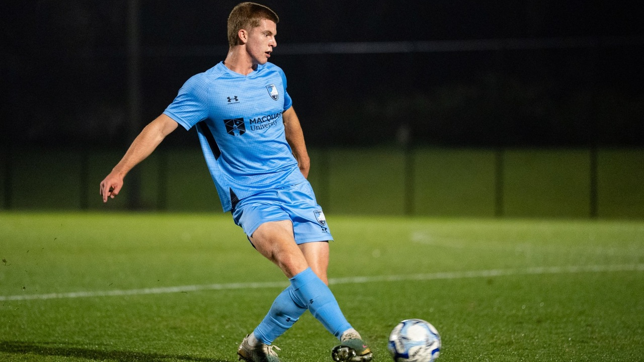 Ethan Dyer competes for the ball in Sydney FC colours