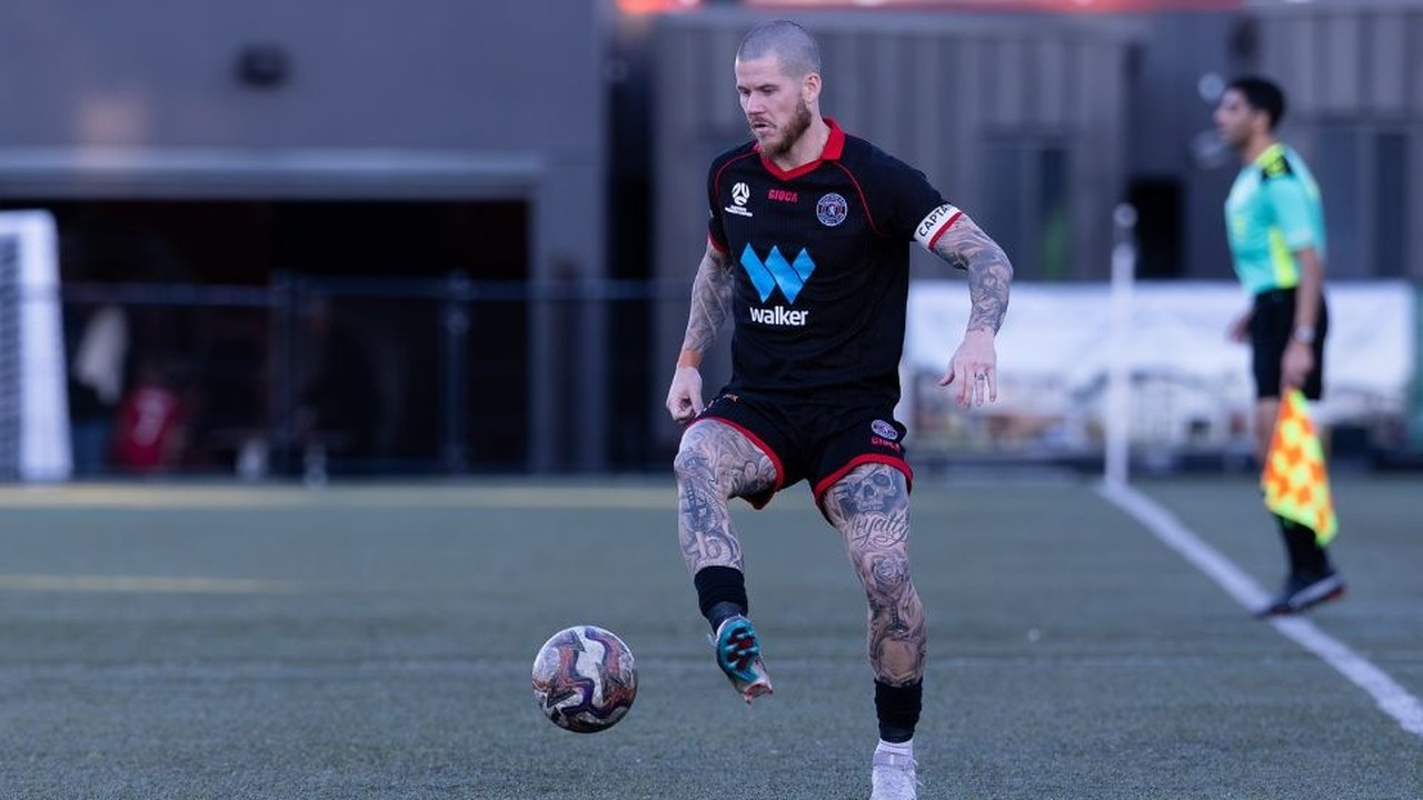 A Sydney United footballer carries the ball during a match