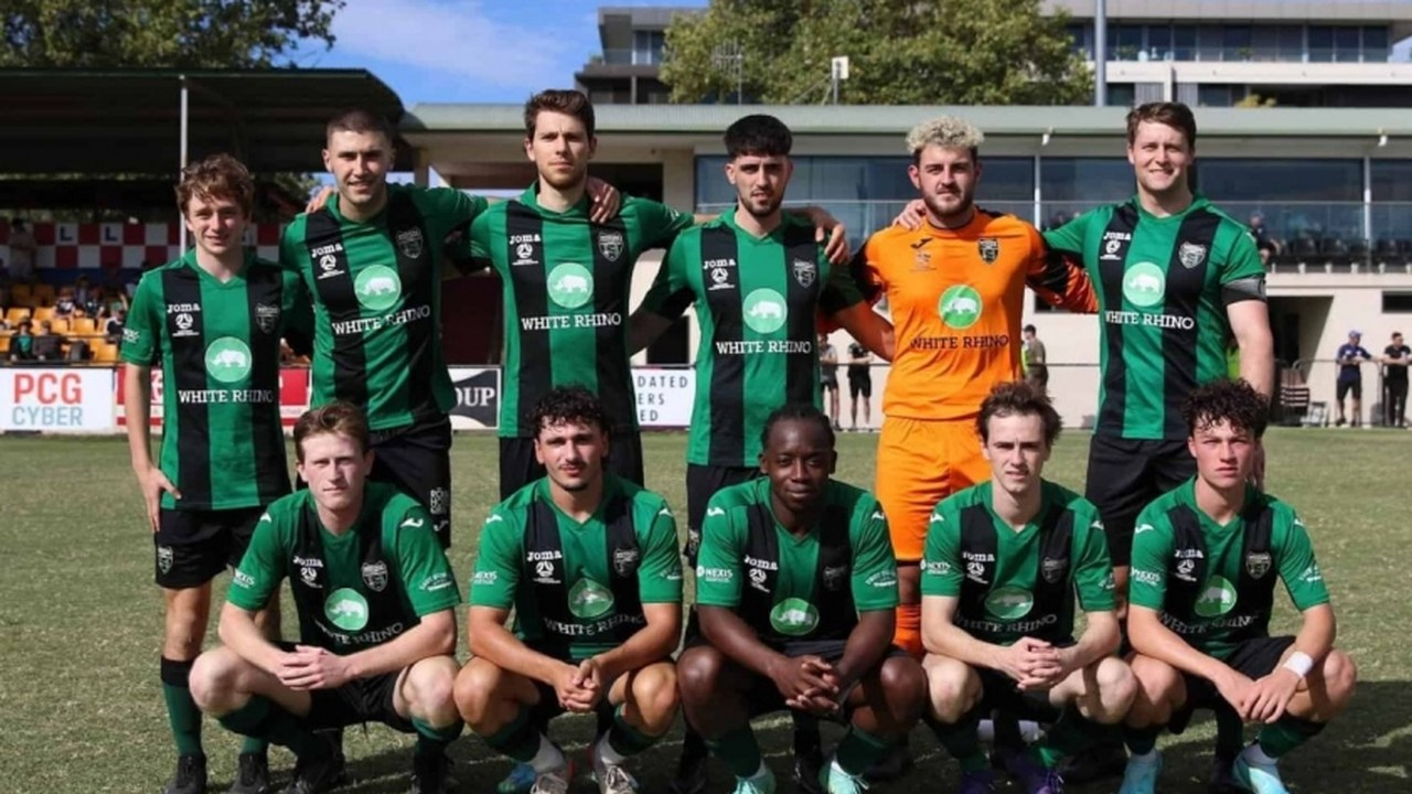 Tigers FC footballers pose together before a match