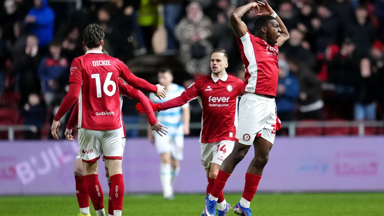 Bristol City players react together during a football match