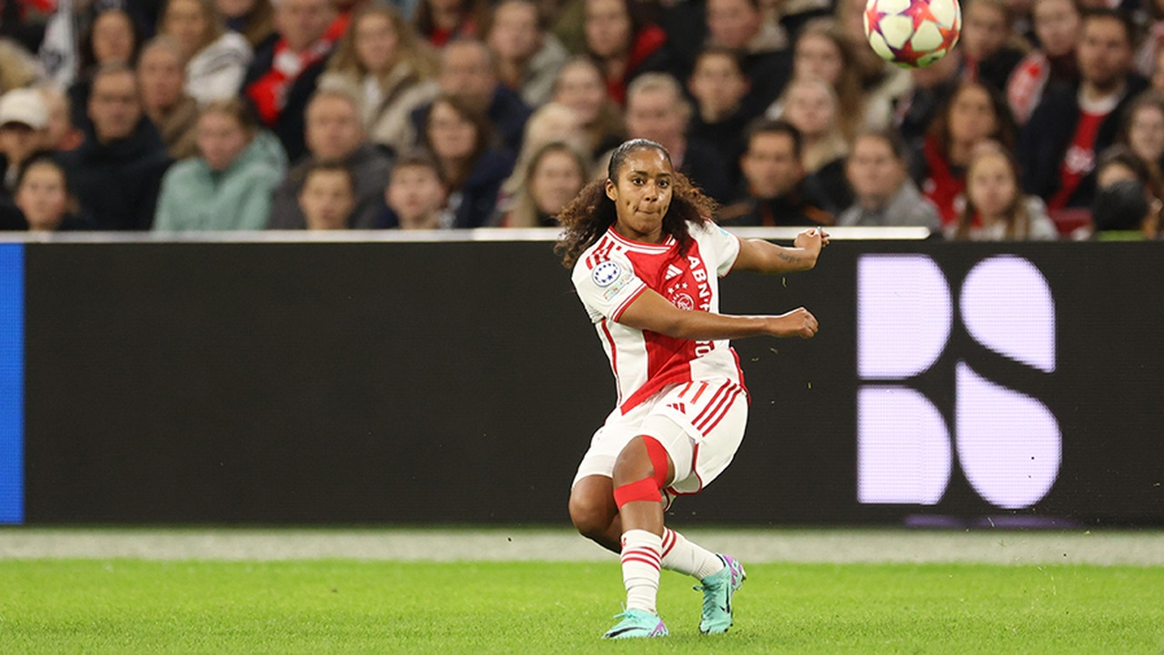 An Ajax Women player passes the ball during a match