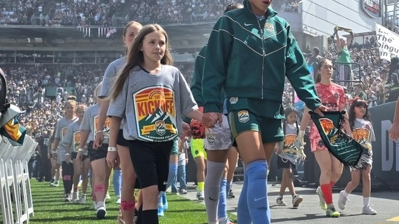 Boston Legacy players walk onto the field with young mascots