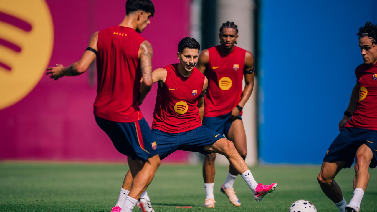 Barcelona players train together on a football pitch
