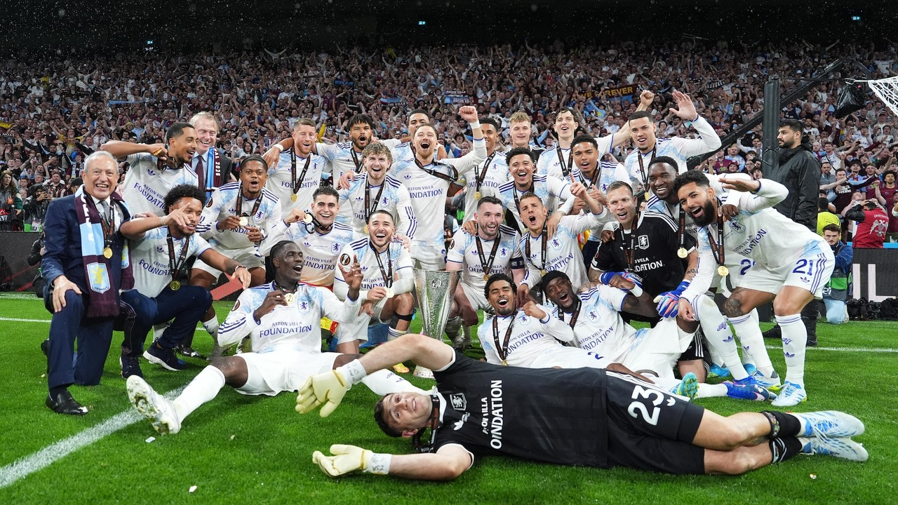 Aston Villa players celebrate together with the Europa League trophy