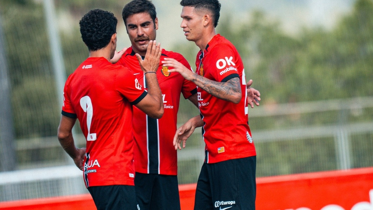 Mallorca footballers celebrate together during a match