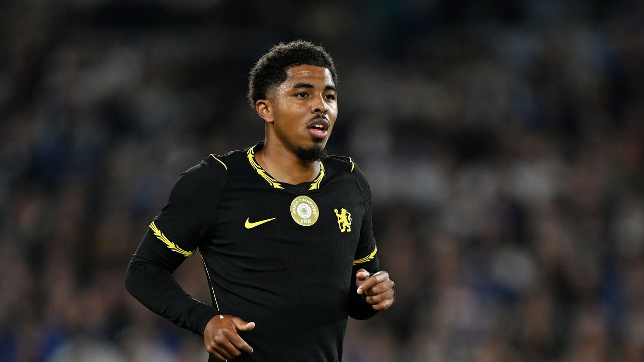 A Chelsea player runs in a black away kit