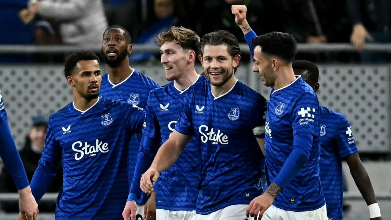 Everton players celebrate together during a football match