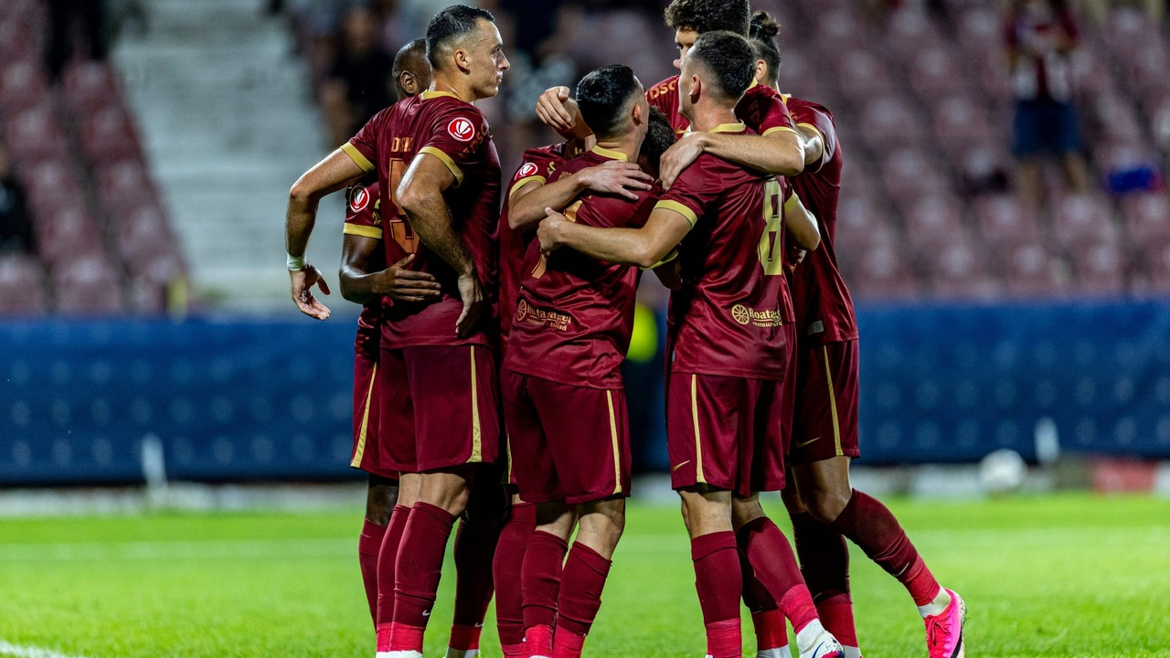 CFR Cluj players form a huddle before a football match